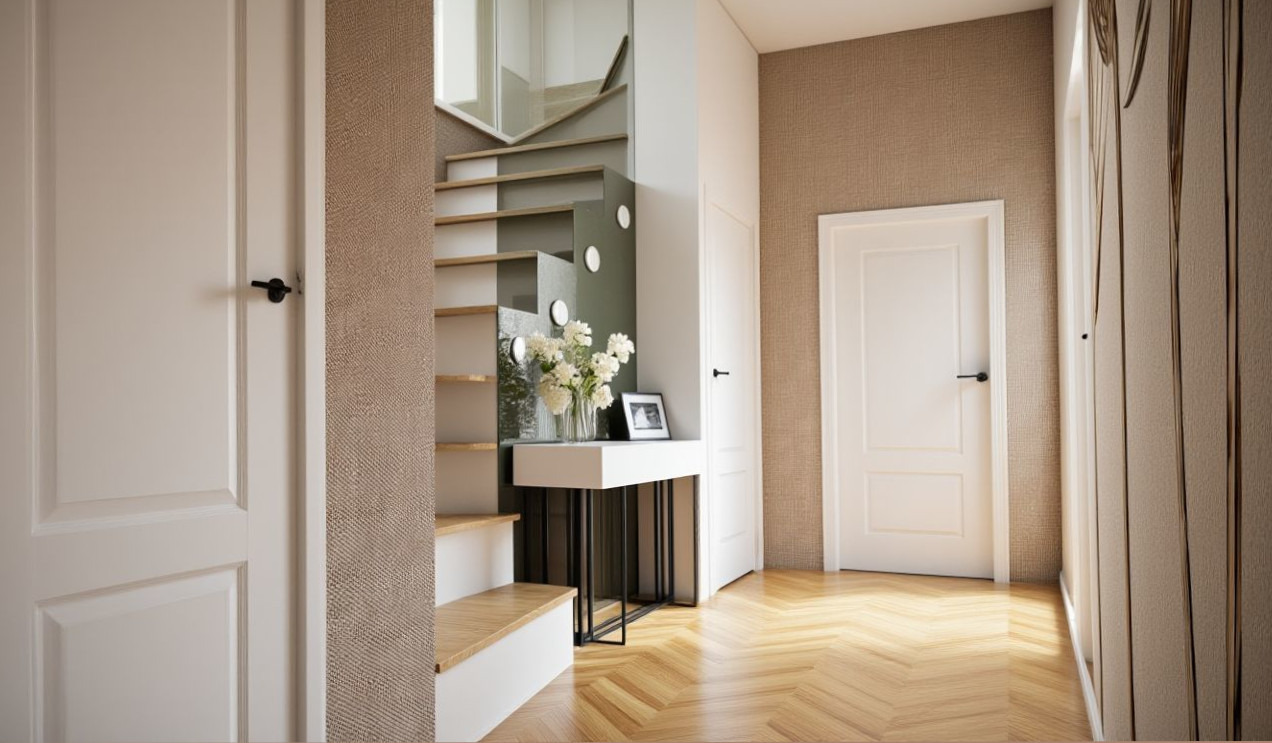 Nowoczesne wnętrze: schody z podświetleniem, parkiet w jodełkę, białe drzwi i dekoracyjna ściana. Minimalistyczny design z kwiatami i ramką na stoliku.