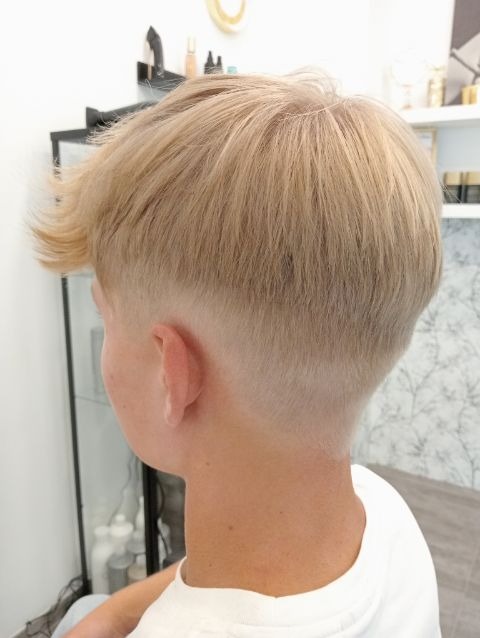 Blond włosy z krótkim tyłem i bokami, dłuższa grzywka opadająca na czoło, widok z boku i tyłu głowy.