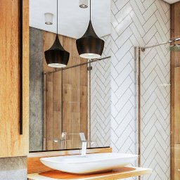 Majster Szklarz - Nowoczesna łazienka z umywalką nablatową, baterią jednouchwytową i kabiną prysznicową ze szklaną ścianką, oświetlona wiszącymi lampami w kształcie kropli.