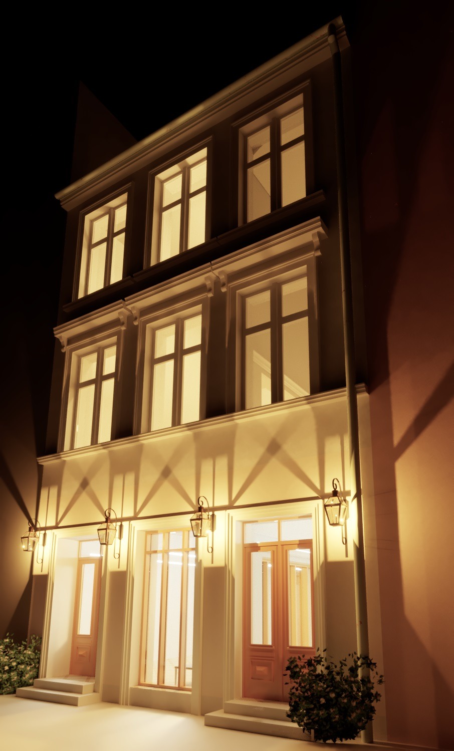 Elewacja trzypiętrowego budynku usługowego oświetlona wieczornym światłem, z widocznymi trzema wejściami i oknami na każdym piętrze, dekoracyjnymi lampami na elewacji i roślinami przy wejściach.