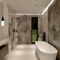 Design Atelier - Nowoczesna aranżacja łazienki w Krakowie z wanną wolnostojącą, kabiną prysznicową typu walk-in i kamiennymi płytkami. Minimalistyczne oświetlenie.