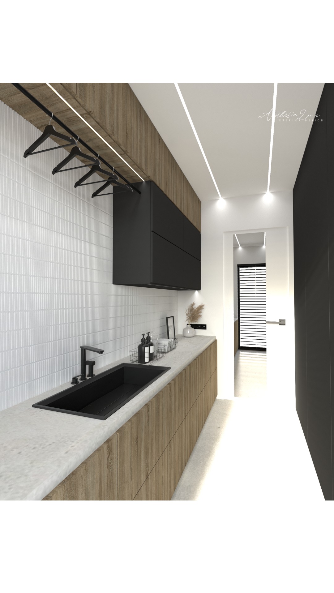 Wizualizacja nowoczesnej pralni w Warszawie: czarny, prostokątny zlew, drewnopodobna szafka pod umywalką, białe płytki na ścianie, czarne szafki wiszące i rząd czarnych wieszaków na ubrania.