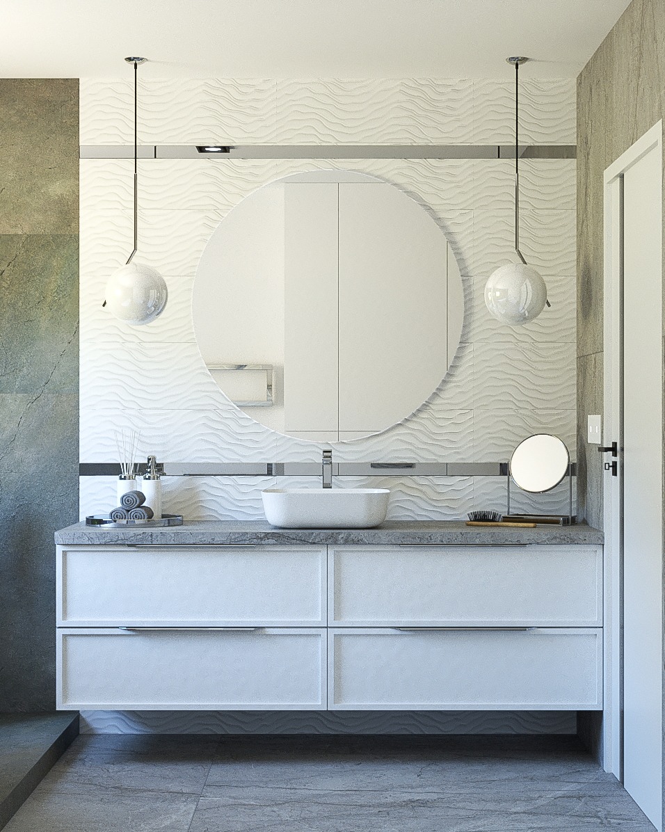 Nowoczesna łazienka z białą szafką pod umywalkę, okrągłym lustrem z szafką, dekoracyjną falistą ścianą, wiszącymi lampami kulami i szarą płytką podłogową.