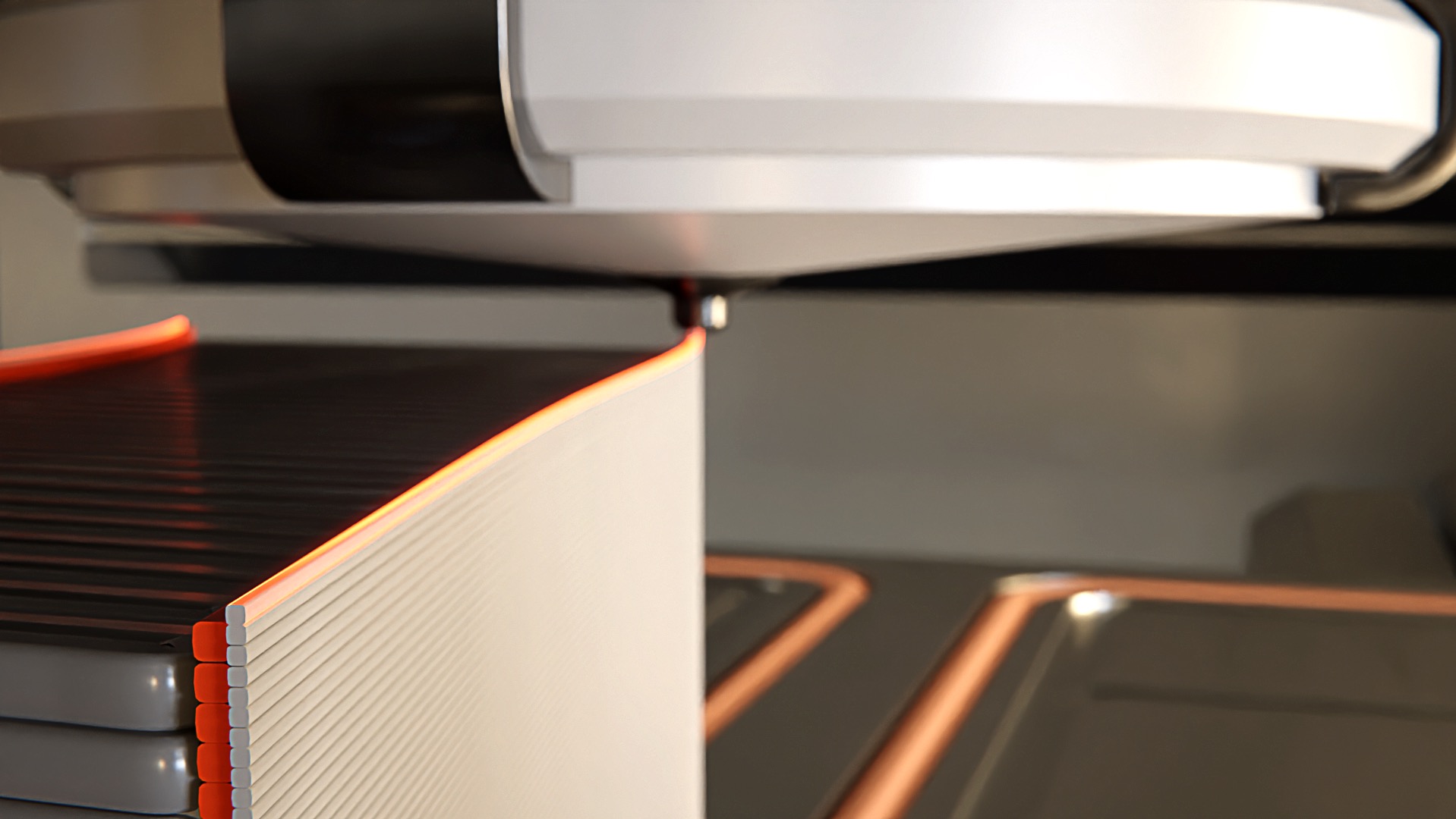 Precyzyjne cięcie warstw materiału przez maszynę CNC z pomarańczowym podświetleniem krawędzi