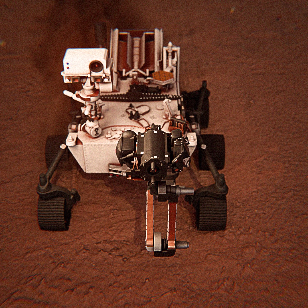 Model łazika marsjańskiego na czerwonej powierzchni, widok z góry, detale konstrukcyjne widoczne.