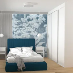 Nowoczesna sypialnia z łóżkiem z turkusowym wezgłowiem, białą pościelą i szarym pledem, na tle ściany z motywem drzew i białej szafy przesuwnej.