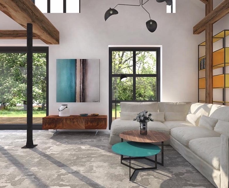 Jasne wnętrze salonu z narożną sofą, okrągłymi stolikami kawowymi i abstrakcyjnym obrazem na ścianie, oświetlone naturalnym światłem z dużych okien.