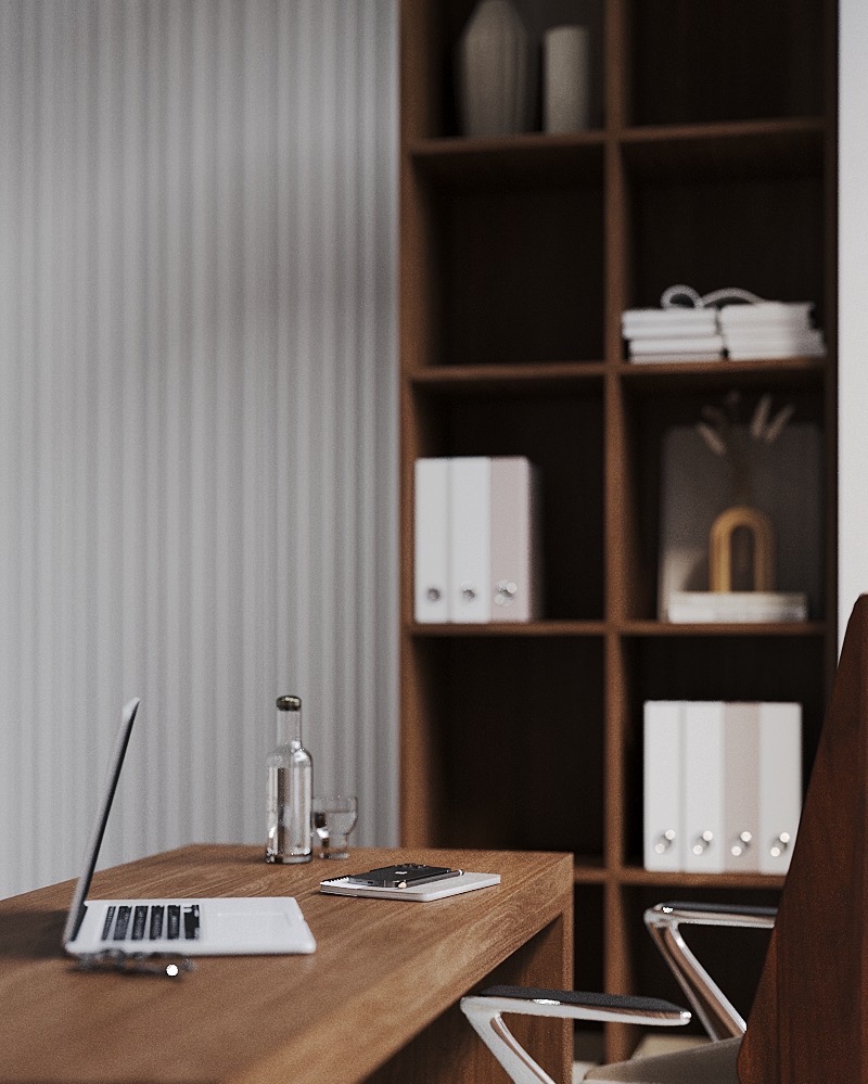 Biurko z laptopem, butelką wody i notatnikiem na tle regału z segregatorami i dekoracjami w neutralnej kolorystyce.