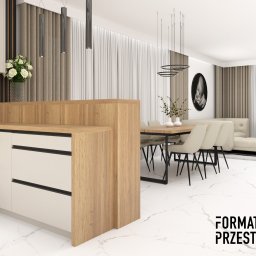 Format Przestrzeni AGNIESZKA BRUŚ-BADLAK - Wizualizacja wnętrza: kuchnia z drewnianą zabudową, marmurowy blat i podłoga, stół jadalny z krzesłami, sofa w tle, nowoczesne oświetlenie.