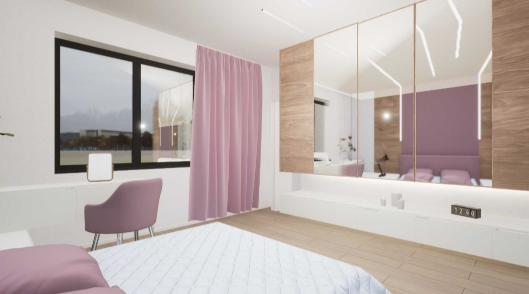 Nowoczesna sypialnia z łóżkiem w odcieniach bieli i różu, duże okno z widokiem na zewnątrz, toaletka z lustrem i krzesłem oraz szafa z lustrzanymi drzwiami i drewnianymi panelami.