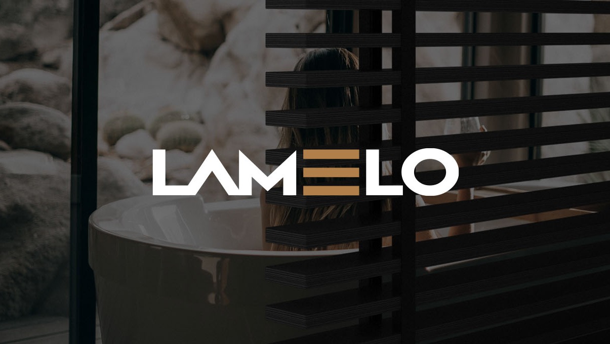 Nowoczesna łazienka z wanną wolnostojącą i żaluzjami poziomymi; logo firmy na pierwszym planie.