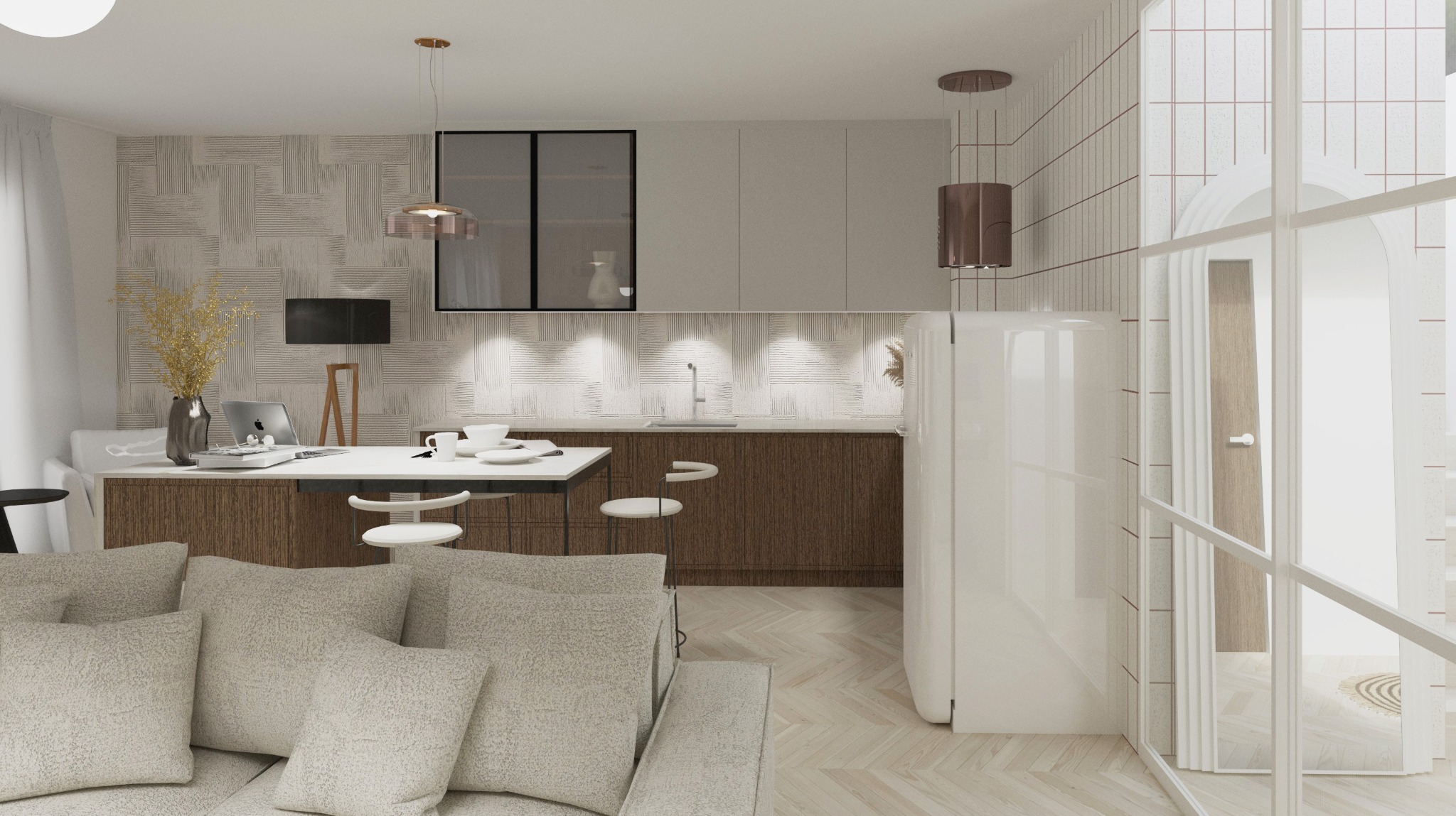 Jasne wnętrze z aneksem kuchennym, drewnianymi szafkami i białym stolikiem z krzesłami. W tle sofa z poduszkami i dekoracyjna ściana. Dominuje minimalizm i ciepła kolorystyka.
