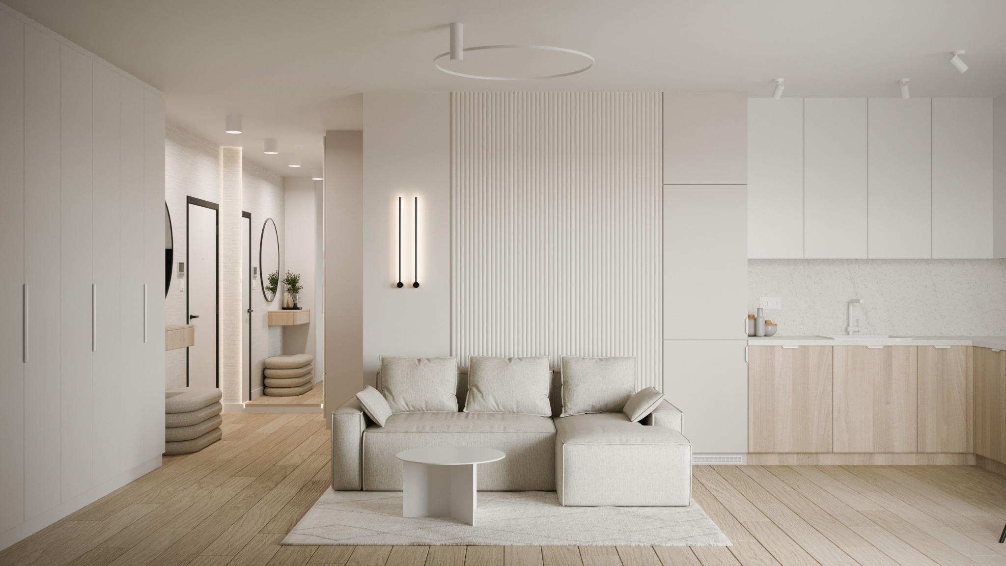 Jasne, przestronne wnętrze mieszkania z drewnianą podłogą, beżową sofą narożną, okrągłym stolikiem kawowym, białą zabudową kuchenną z drewnianymi frontami oraz przedpokojem z lustrami w czarnych...