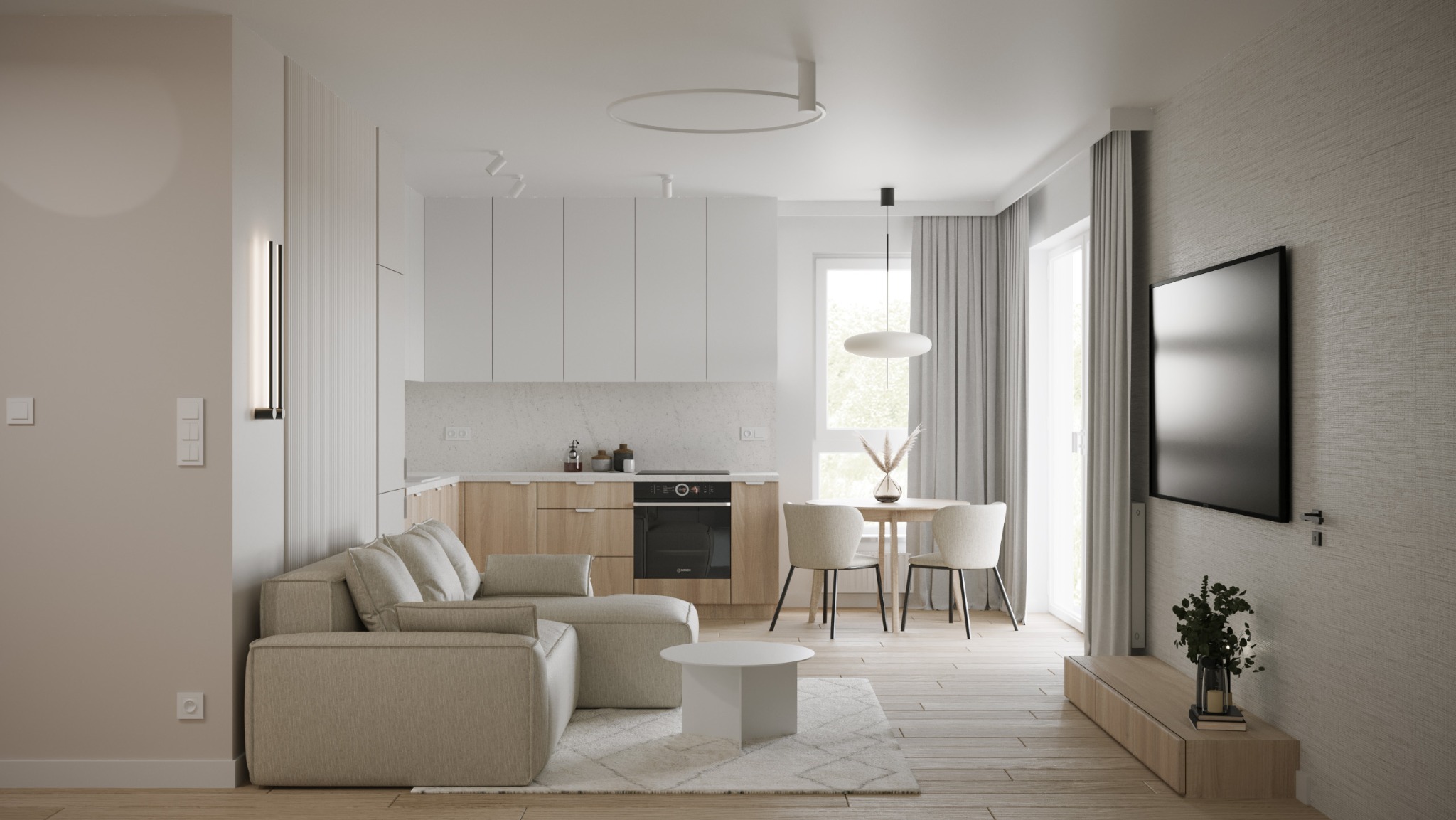 Jasne, przestronne wnętrze mieszkania z aneksem kuchennym, sofą narożną i telewizorem na ścianie w neutralnej kolorystyce.