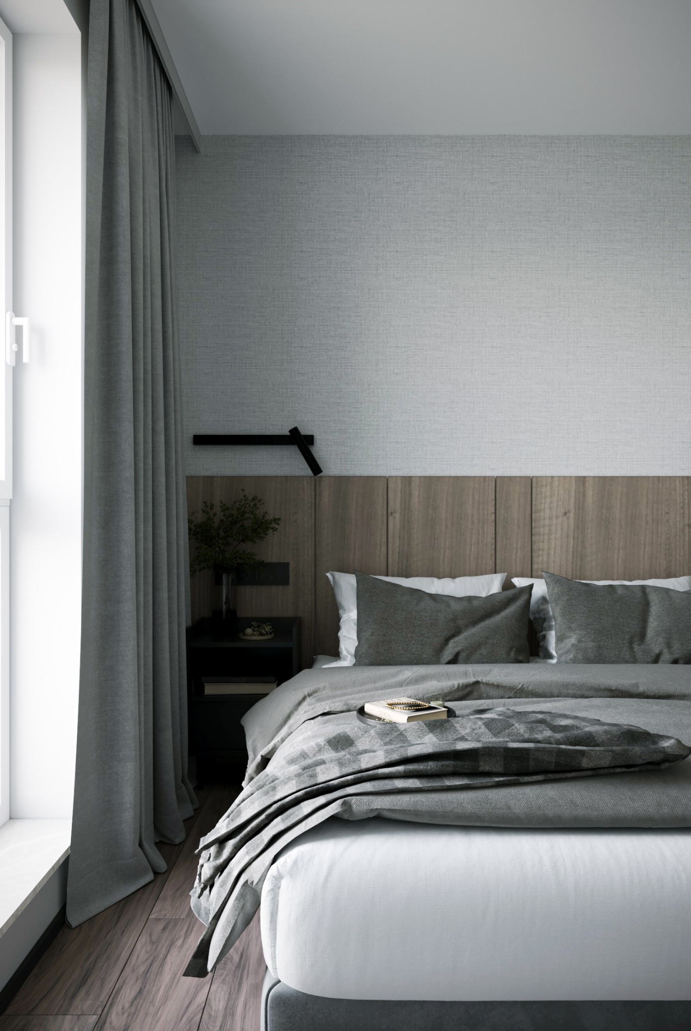 Minimalistyczna sypialnia w odcieniach szarości z drewnianym zagłówkiem, zasłoniętym oknem i książką na łóżku.