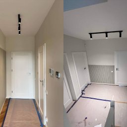 Taras I kompania - Dwa ujęcia korytarza w trakcie prac wykończeniowych: po lewej wykończona ściana z pionowymi panelami i parkietem zabezpieczonym folią, po prawej pomieszczenie z przygotowanym podłożem, listwami...