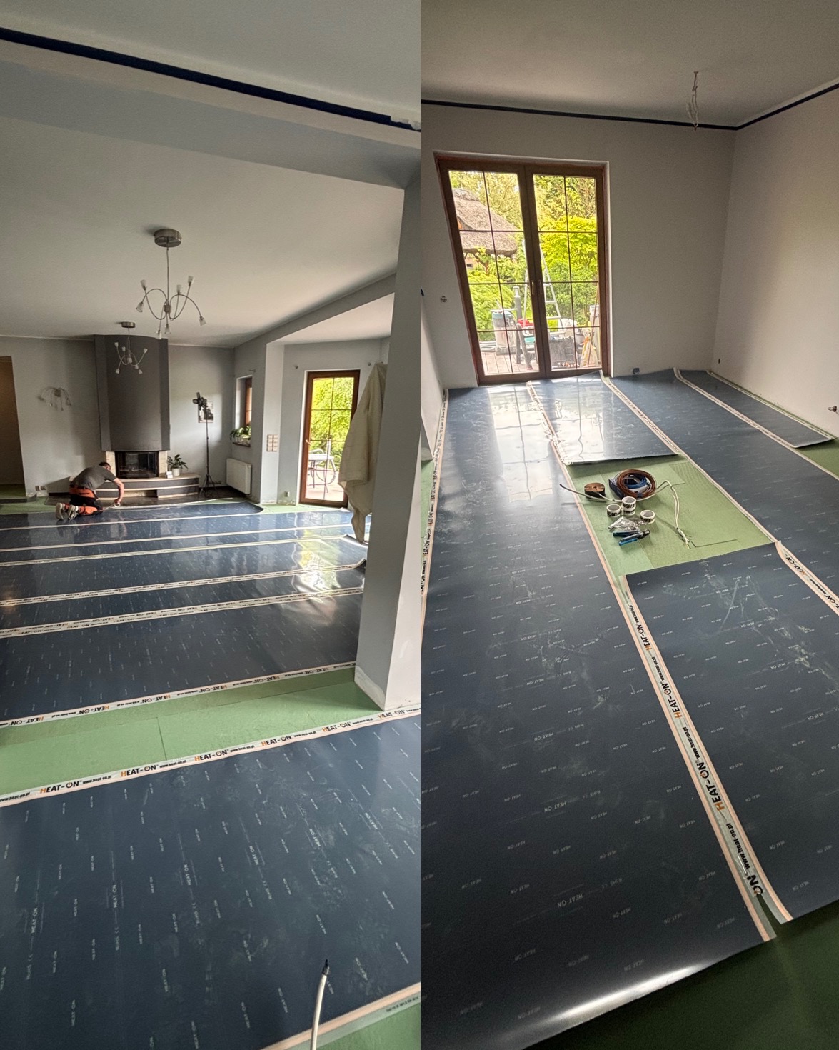Układanie folii grzewczej HEAT-ON na podłodze w przestronnym pokoju z kominkiem i dużym oknem. Prace w toku, widoczny instalator. Etap przygotowania do dalszych prac wykończeniowych.