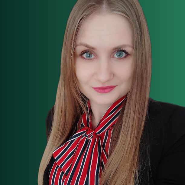 Portret uśmiechniętej kobiety z długimi blond włosami, ubranej w czarną marynarkę i bluzkę w czerwono-granatowe paski, na zielonym tle.