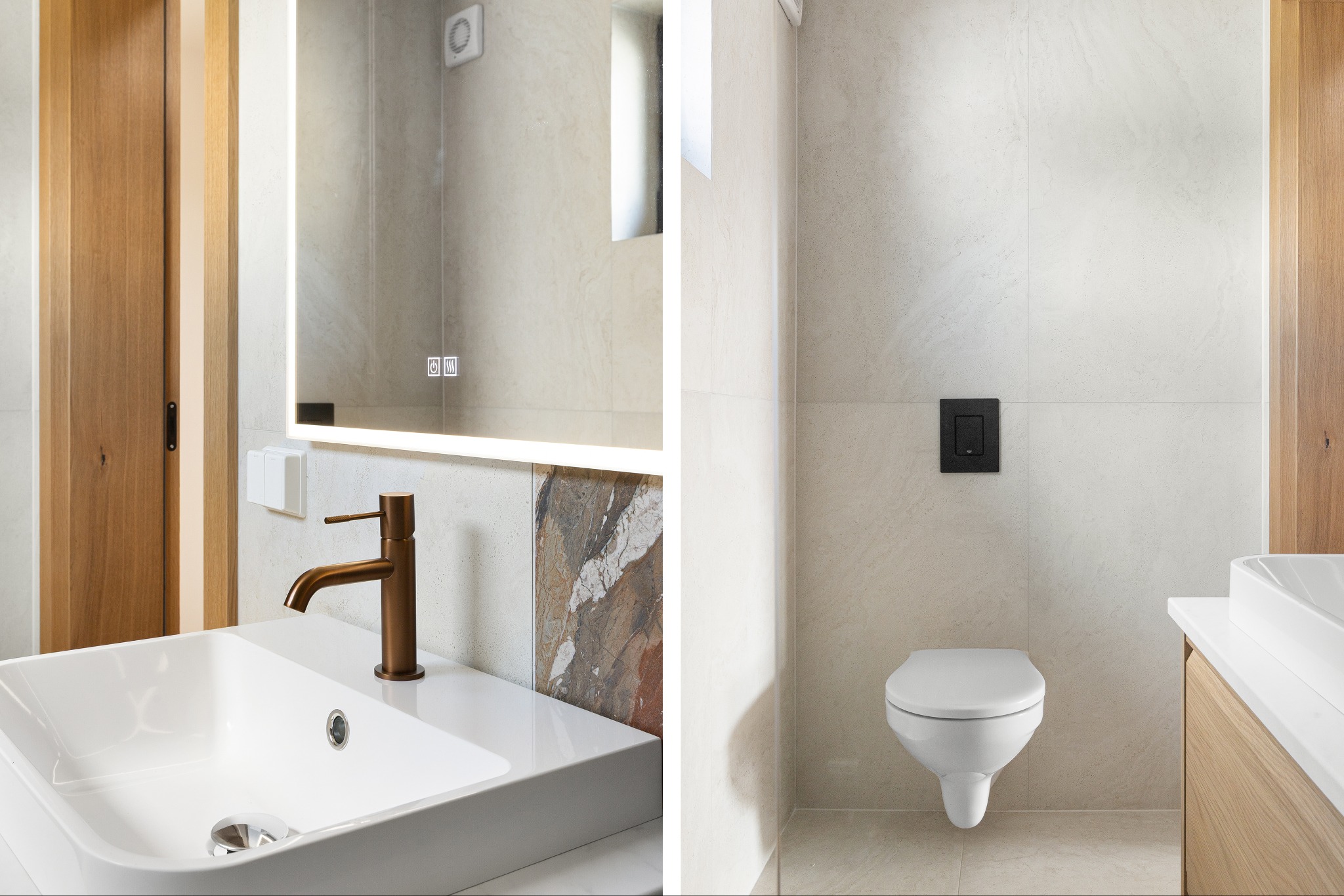 Nowoczesna łazienka z białymi płytkami, umywalką z brązową baterią i podświetlanym lustrem. Widoczna toaleta podwieszana z czarnym przyciskiem.
