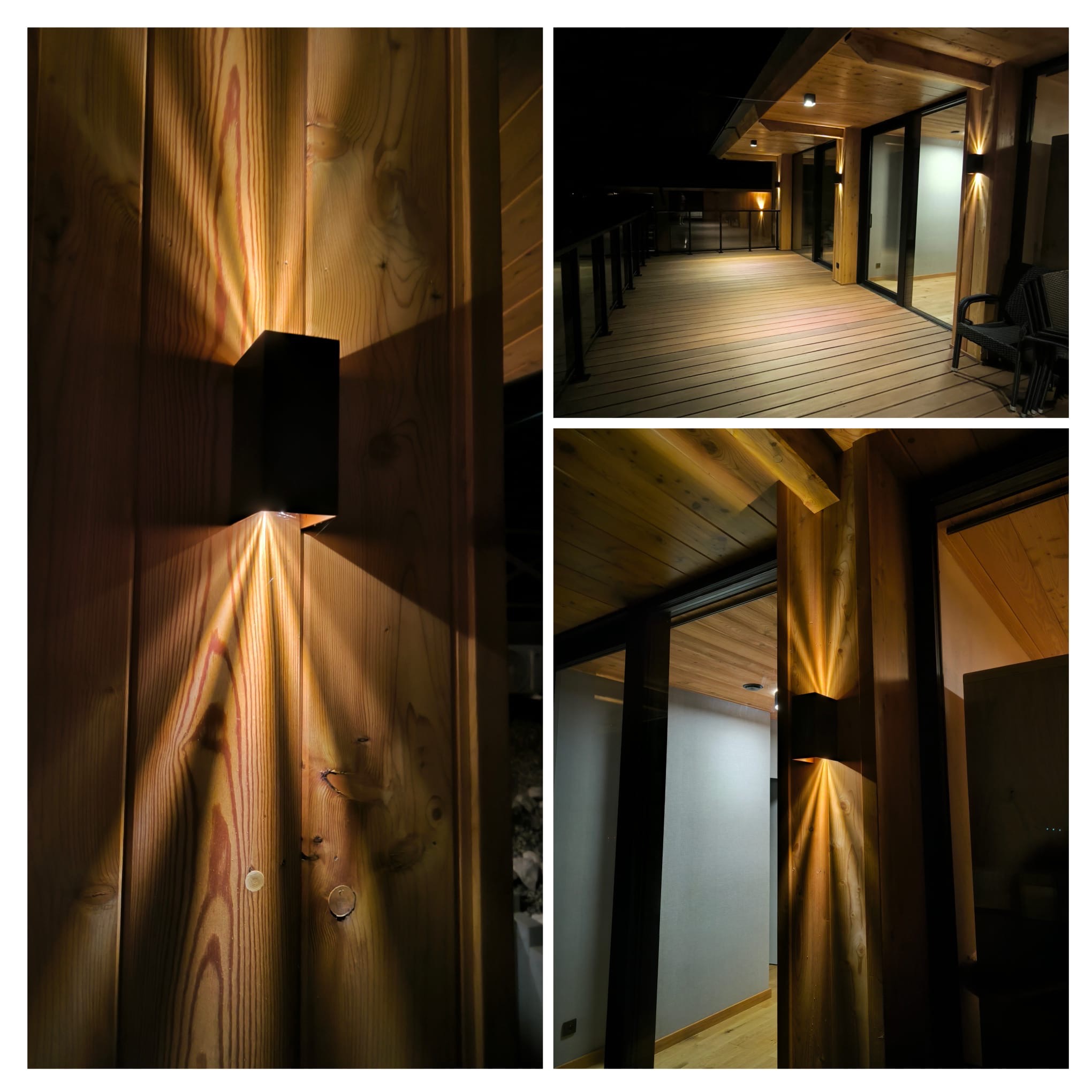 Nowoczesne oświetlenie elewacyjne: czarne, prostopadłościenne lampy rzucają ciepłe, trójkątne snopy światła na drewnianą fasadę budynku z tarasem.