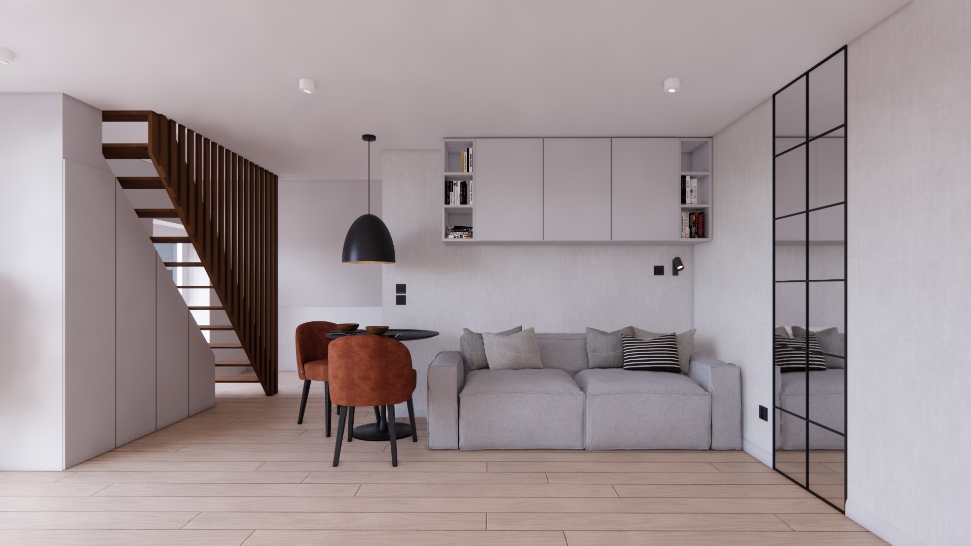 Nowoczesne wnętrze: jasne drewniane podłogi, szara sofa z poduszkami, okrągły stół z pomarańczowymi krzesłami, schody z drewnianą balustradą, białe szafki wiszące i czarna lampa wisząca.