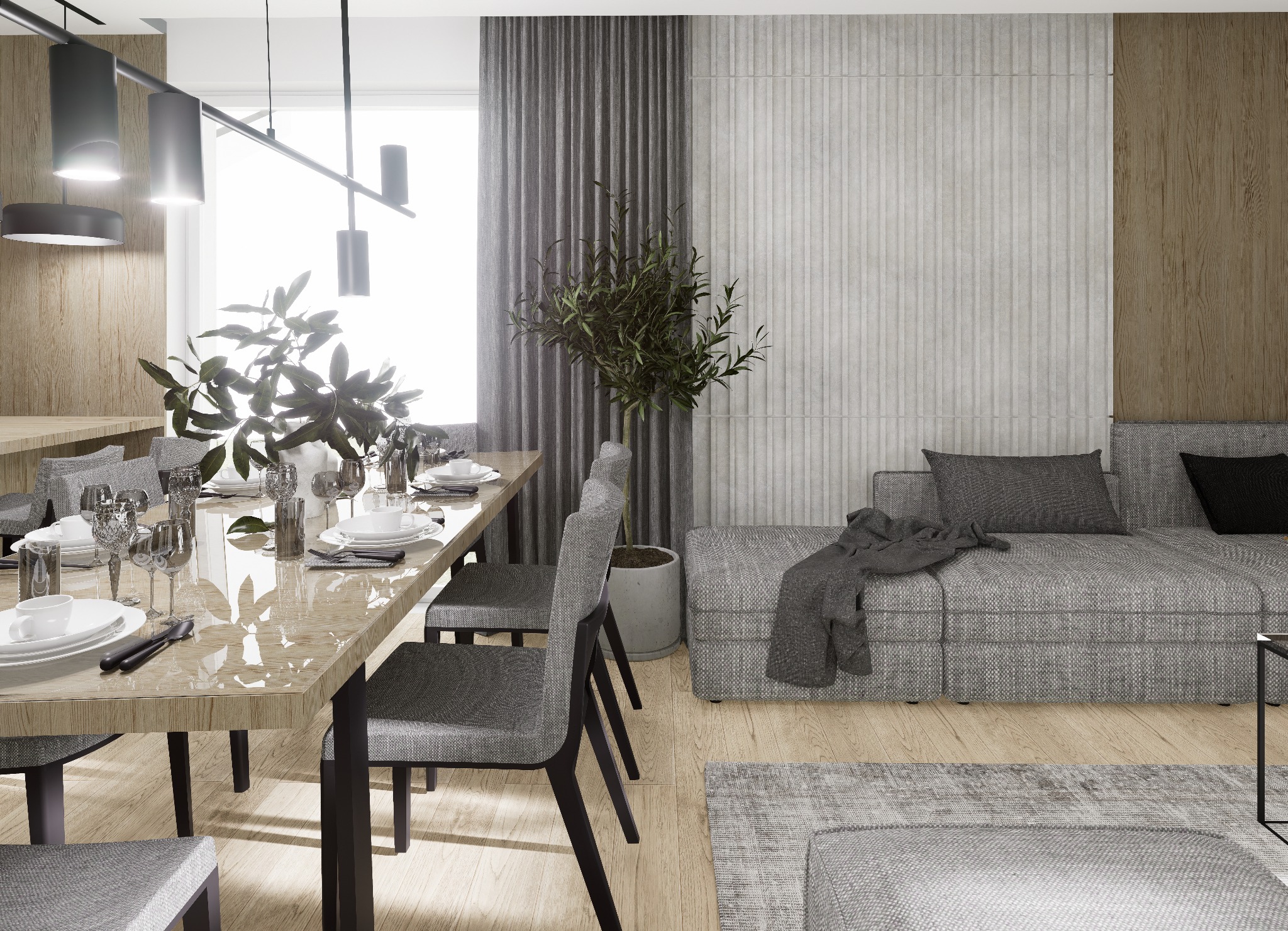 Jasne wnętrze: stół z nakryciem, szare krzesła, sofa narożna z poduszkami i pledem, drewniana podłoga, rośliny doniczkowe, nowoczesne oświetlenie.