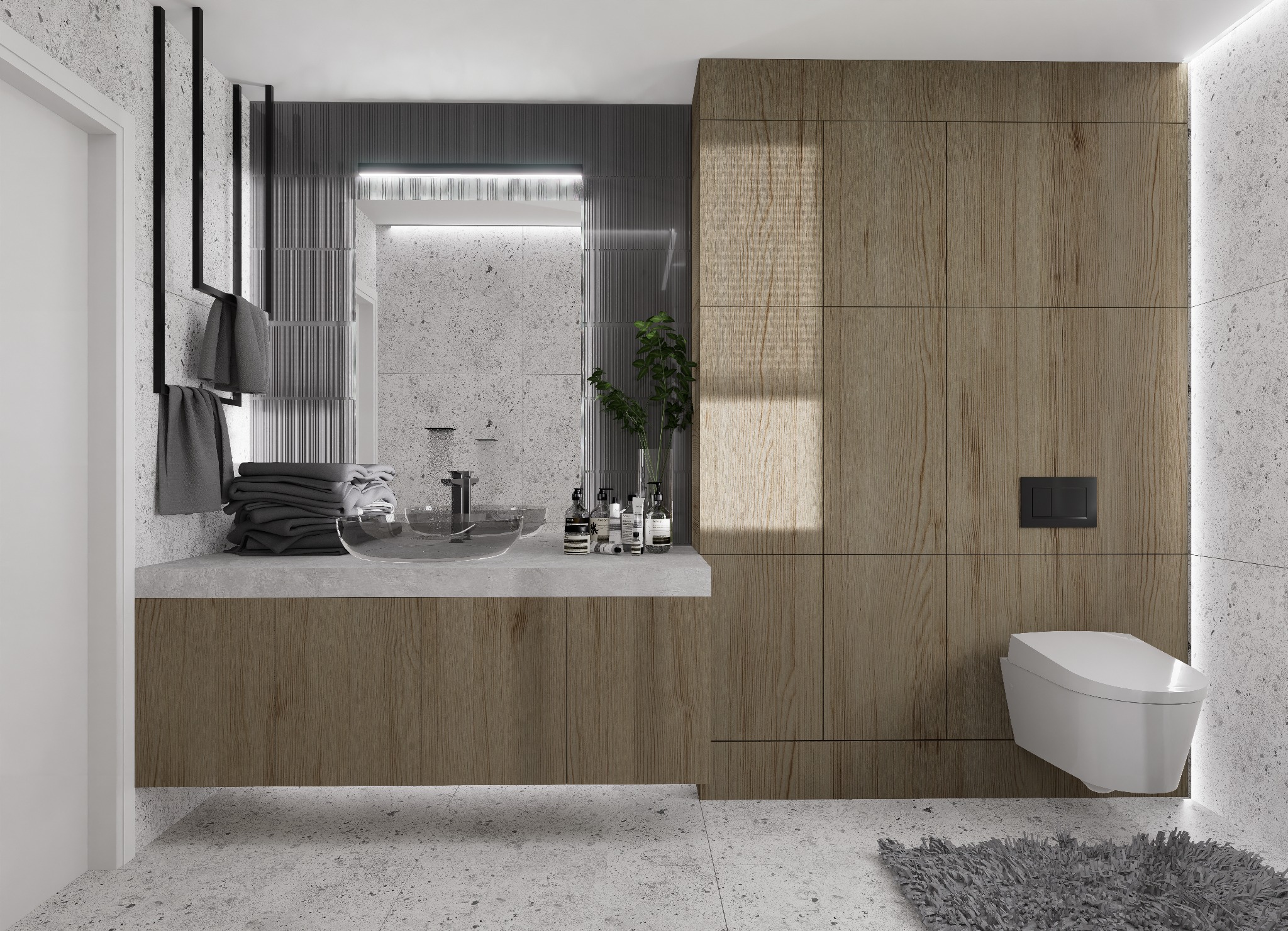 Nowoczesna łazienka z umywalką ze szkła, drewnianą zabudową, toaletą podwieszaną i szarą armaturą, wykończona płytkami imitującymi lastryko.