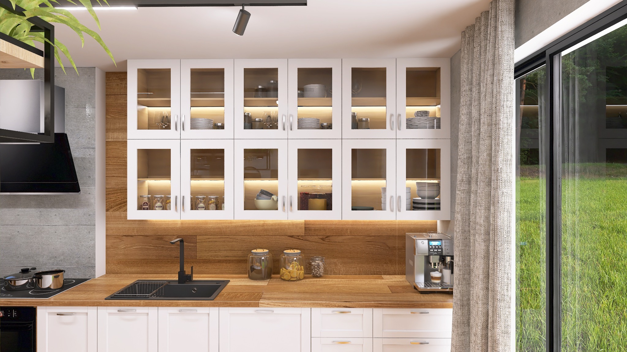 Nowoczesna kuchnia z białymi szafkami, drewnianym blatem i przeszklonymi szafkami wiszącymi z podświetleniem LED, widok na zieleń przez okno.