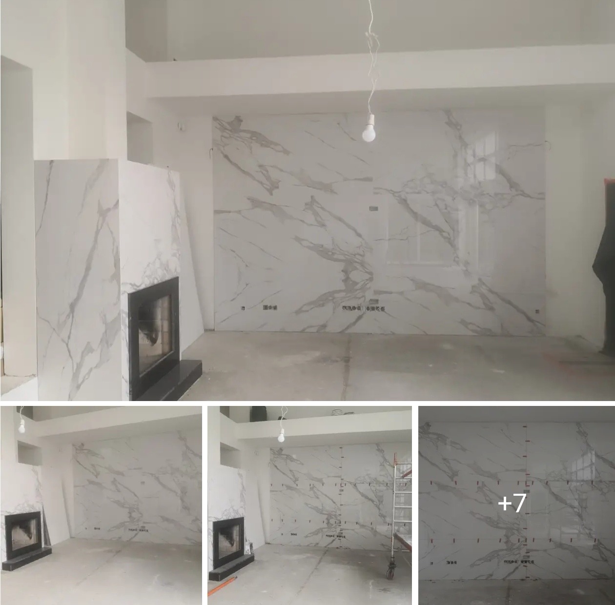 Salon z marmurowymi płytami na ścianie i obudowie kominka, surowy stan, widoczne punkty pomiarowe na ścianie, wisząca żarówka, jasne wnętrze.