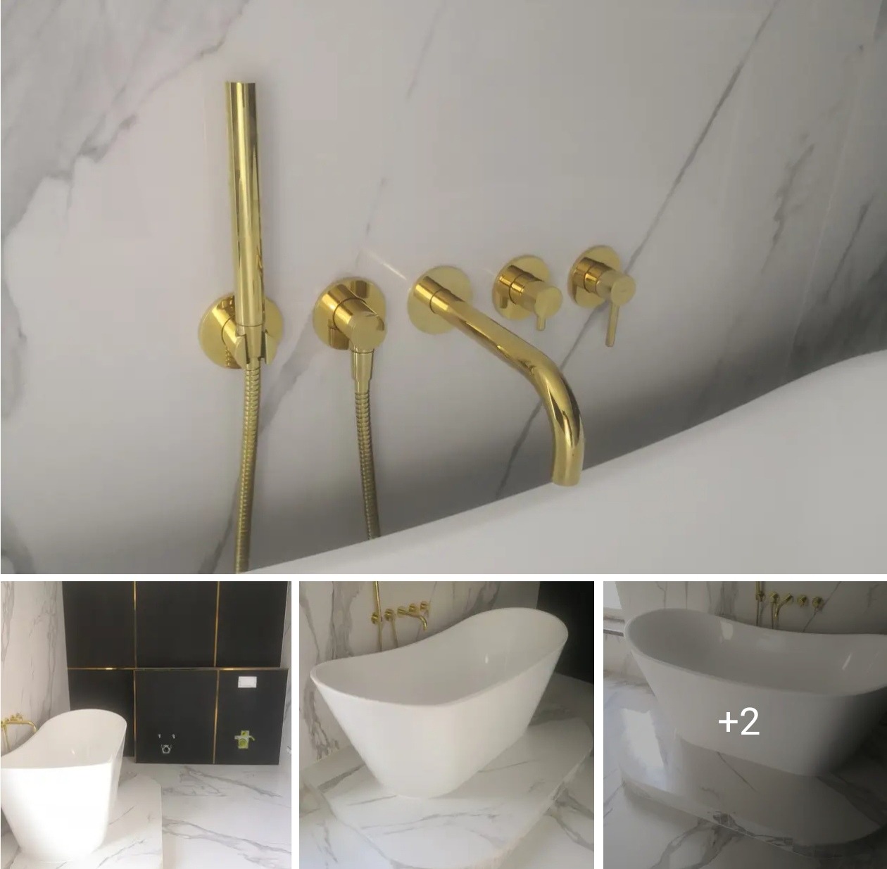 Biała wanna wolnostojąca z armaturą w kolorze złotym na tle marmurowej ściany i podłogi. Widoczne detale wykończenia łazienki.