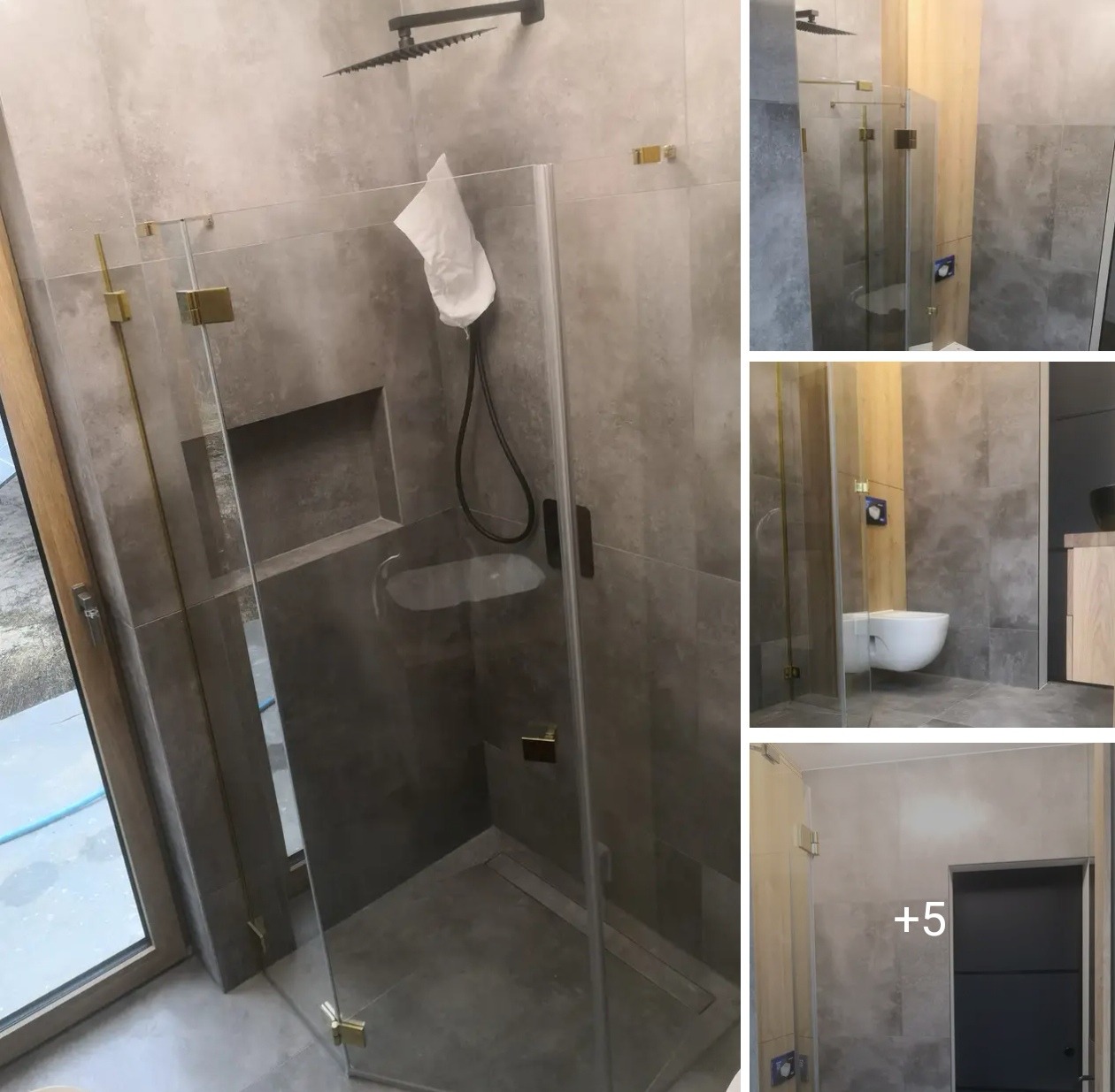 Nowoczesna kabina prysznicowa z szarymi płytkami, złotymi okuciami i deszczownicą. Minimalistyczny design łazienki z elementami drewna i wiszącą toaletą.