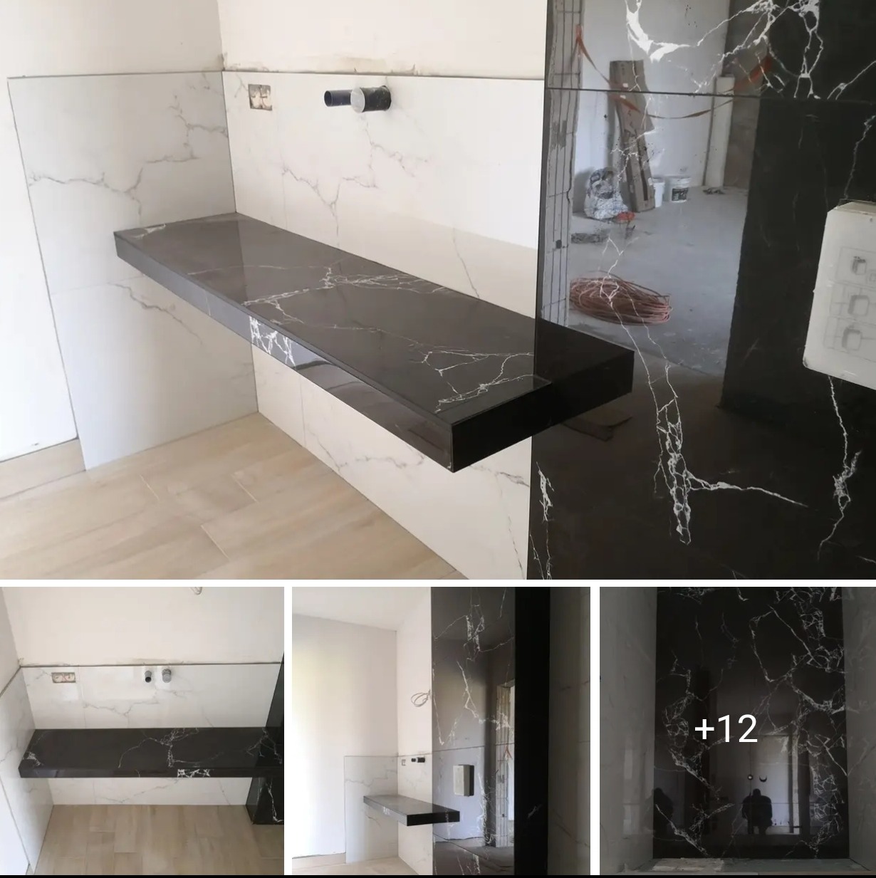 Wykończona łazienka: czarny blat z marmurowym wzorem, białe płytki ścienne z szarymi żyłkami, jasna podłoga. Widoczne elementy instalacji.