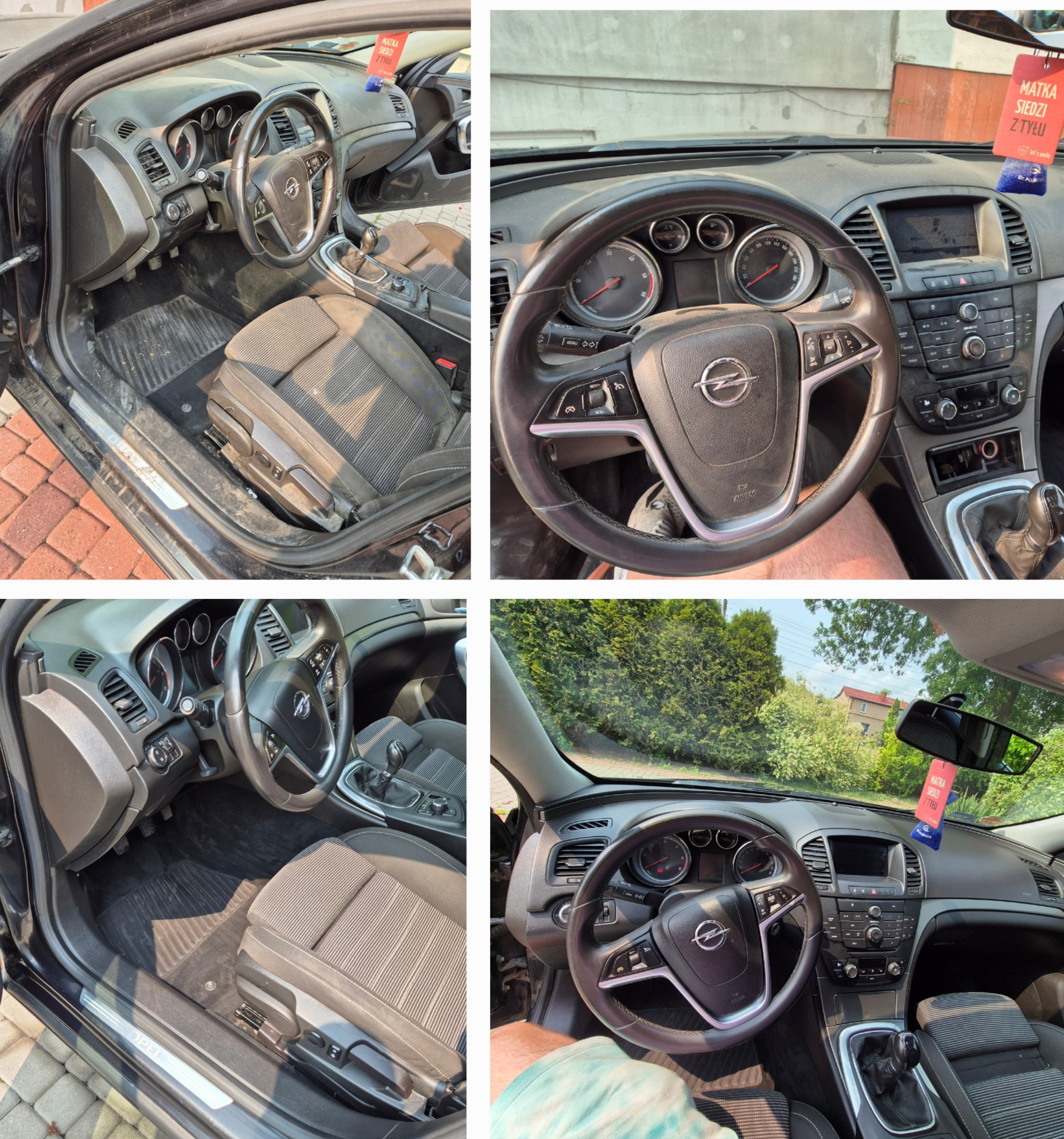 Wnętrze czarnego Opla Insignia przed czyszczeniem: brudna deska rozdzielcza, kierownica i fotele wymagają odświeżenia. Widoczne ślady kurzu i zabrudzeń na elementach wyposażenia.
