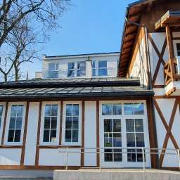 Fasada Windows & Doors - Zabytkowy budynek w Grodzisku Mazowieckim. Okna i drzwi drewniane, białe + szpros wiedeński biały.