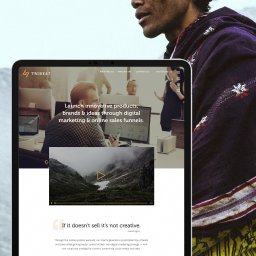 Bartosz Dymek - Ekran laptopa wyświetlający projekt strony internetowej z nagłówkiem 'Launch innovative products, brands & ideas through digital marketing & online sales funnels', logo 'TRIBE47' w lewym górnym...