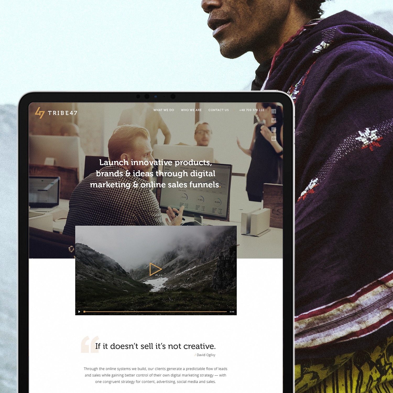 Ekran laptopa wyświetlający projekt strony internetowej z nagłówkiem 'Launch innovative products, brands & ideas through digital marketing & online sales funnels', logo 'TRIBE47' w lewym górnym...