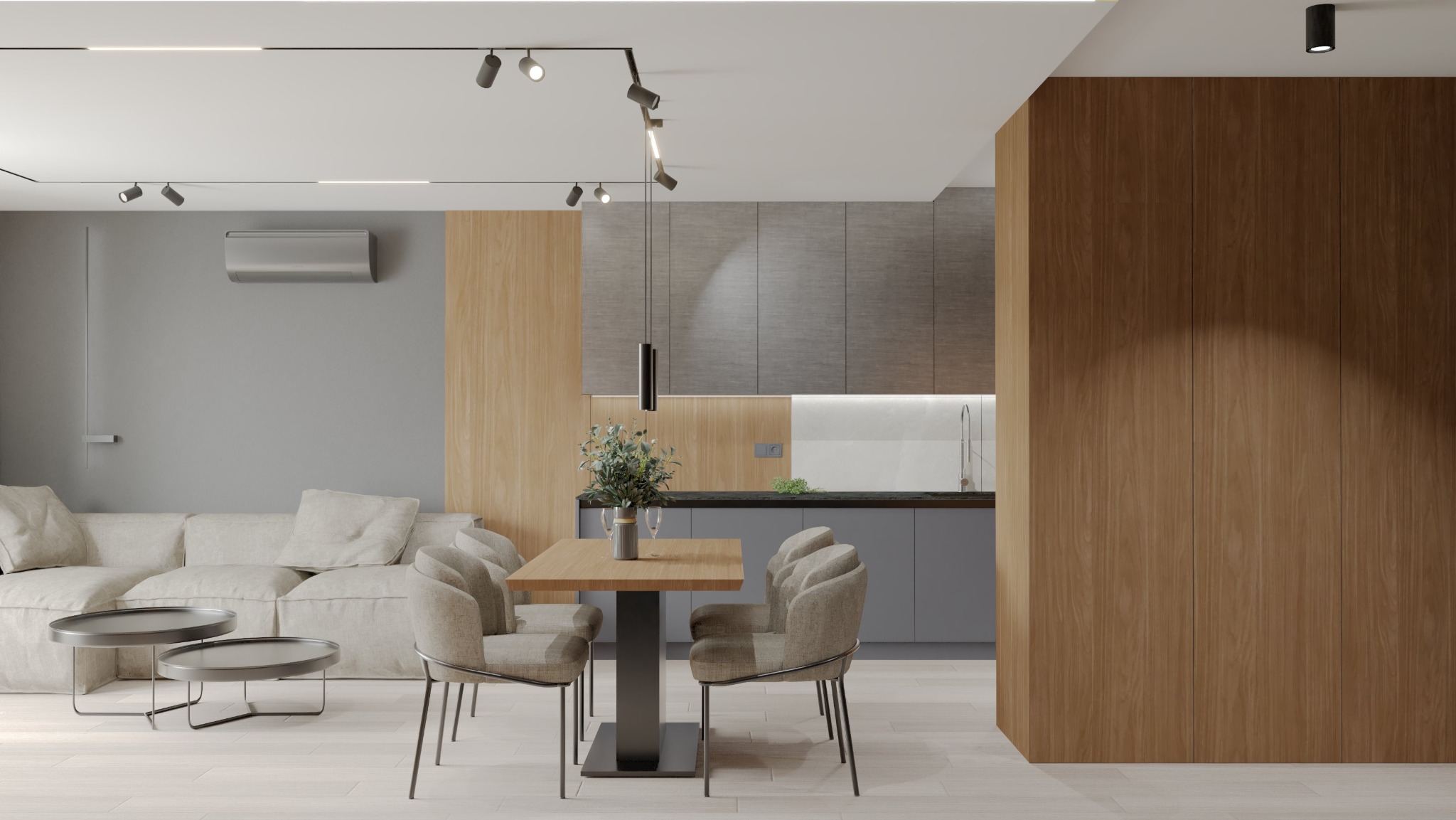 Nowoczesne wnętrze mieszkania z otwartą kuchnią, drewnianymi akcentami, szarą zabudową kuchenną i beżową sofą w tle.