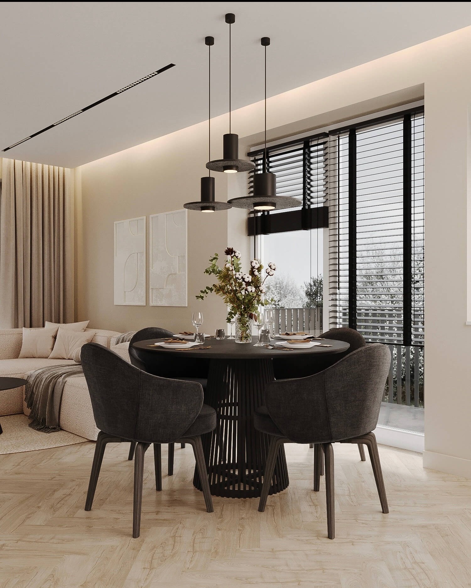 Jadalnia w neutralnych barwach z okrągłym stołem, czterema krzesłami i trzema wiszącymi lampami. Za stołem znajduje się okno z żaluzjami, a w tle widoczny jest salon z beżową sofą.