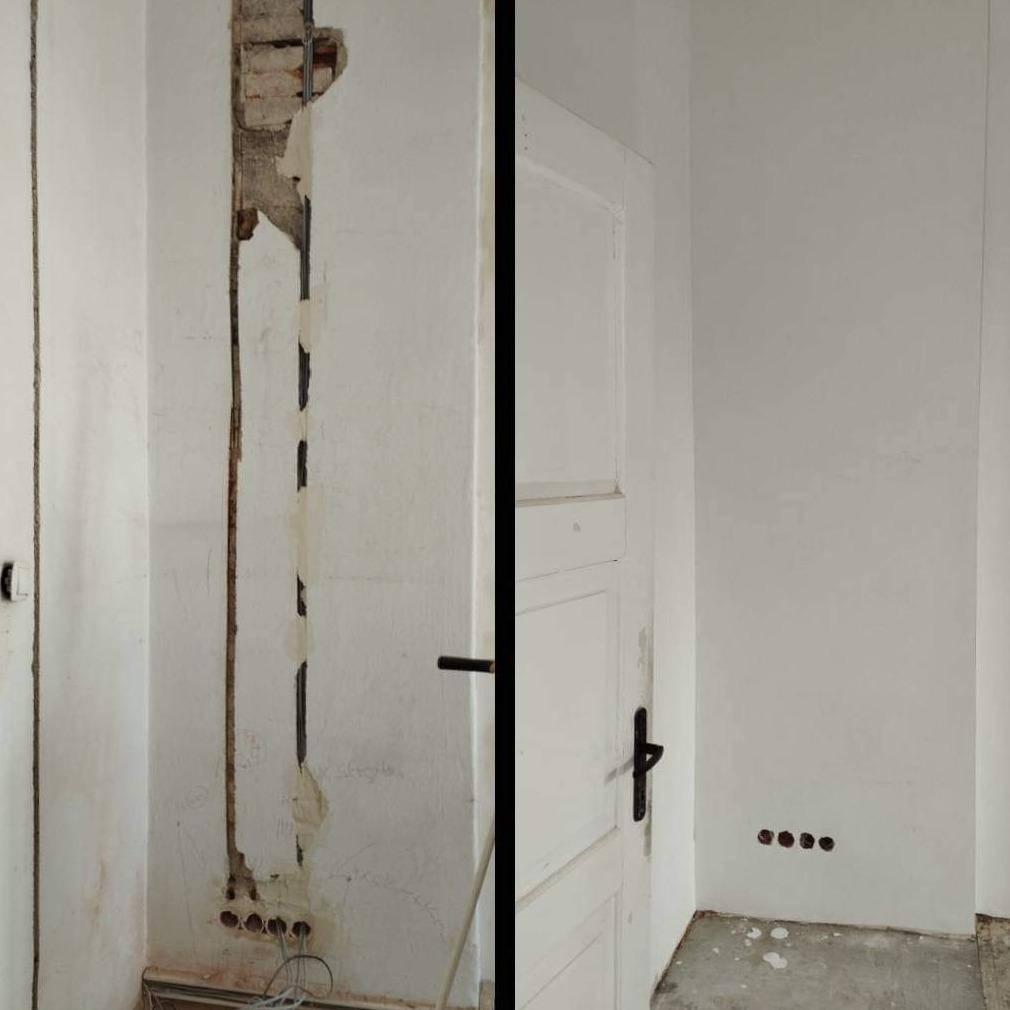 Fragment ściany starej kamienicy w trakcie naprawy: widoczne bruzdy pod instalacje elektryczne, częściowo zaklejone taśmą, oraz otwory pod gniazdka; obok odnowione fragmenty ściany i białe drzwi...