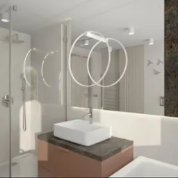 Wizualizacja łazienki z kabiną prysznicową typu walk-in, umywalką nablatową na szafce w kolorze pudrowego różu z blatem imitującym kamień, okrągłym oświetleniem LED nad lustrem oraz dekoracyjną...