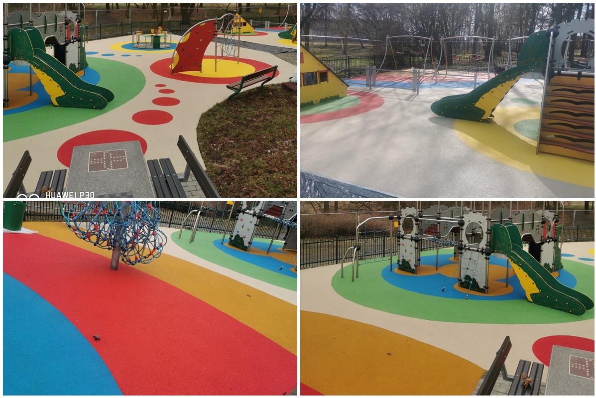 Wielobarwna nawierzchnia bezpieczna na placu zabaw z elementami do wspinaczki, zjeżdżalniami i stolikiem do gier plenerowych.