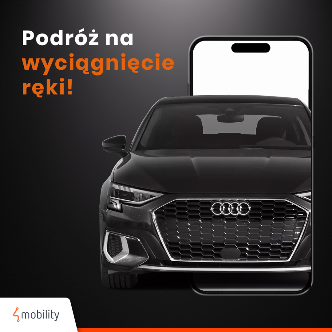 Czarny samochód Audi widziany przez ekran smartfona z hasłem 'Podróż na wyciągnięcie ręki!' na ciemnym tle, logo 4mobility w lewym dolnym rogu.