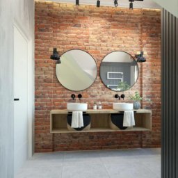 REMONTY I WYKOŃCZENIA PROFESIONALNIE-MATBUDPROFESIONAL MATEUSZ SIKORA - Nowoczesna łazienka w Gdańsku z umywalkami nablatowymi, okrągłymi lustrami na tle ściany z czerwonej cegły i oświetleniem punktowym. Białe ręczniki w ozdobnych koszach pod umywalkami.