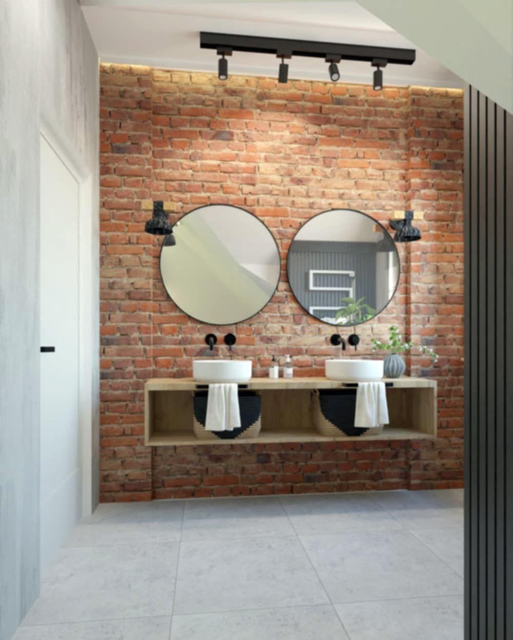 Nowoczesna łazienka w Gdańsku z umywalkami nablatowymi, okrągłymi lustrami na tle ściany z czerwonej cegły i oświetleniem punktowym. Białe ręczniki w ozdobnych koszach pod umywalkami.