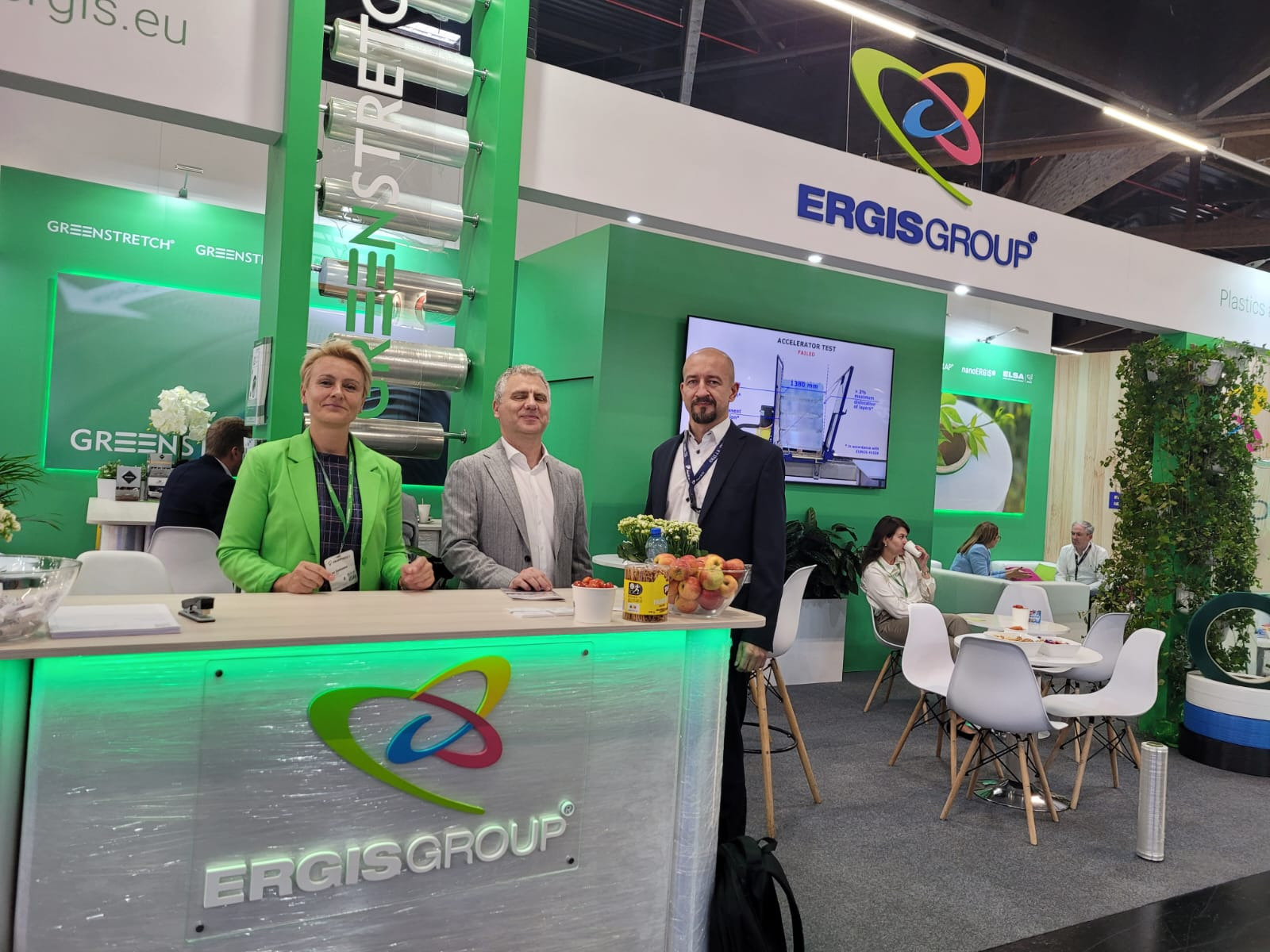 Stoisko targowe firmy Ergis Group z prezentacją folii stretch, z trzema osobami stojącymi za ladą z logo firmy oraz ekspozycją produktów i materiałów reklamowych.