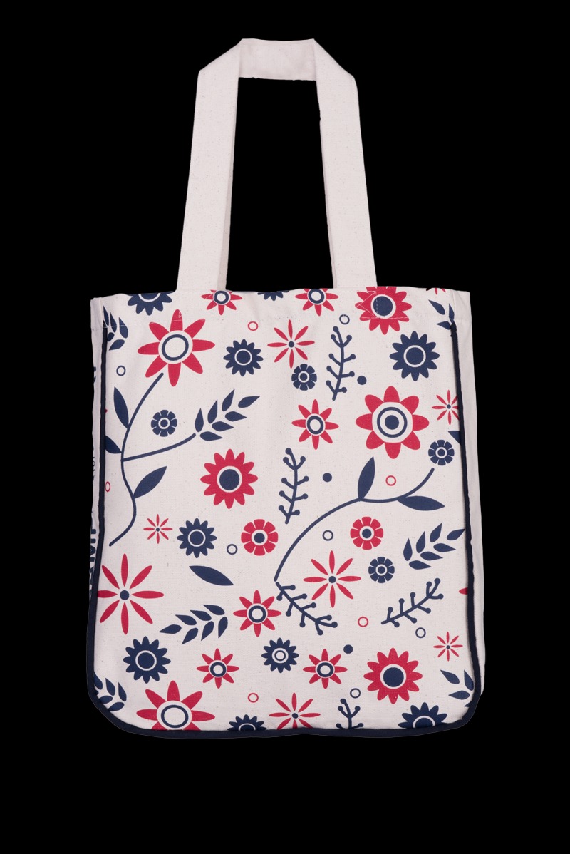 Torba bawełniana z nadrukiem czerwono-granatowych kwiatów i liści na kremowym tle, widok z przodu.