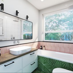 Anna Ostrowska - Nowoczesna łazienka z umywalką nablatową, lustrem w czarnej ramie, wanną z geometrycznym wzorem i roślinami doniczkowymi