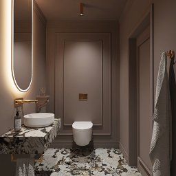 Space Between Pracownia Projektowa Patrycja Piróg - Elegancka łazienka w odcieniach brązu z marmurową umywalką, podświetlanym lustrem i wiszącą toaletą.