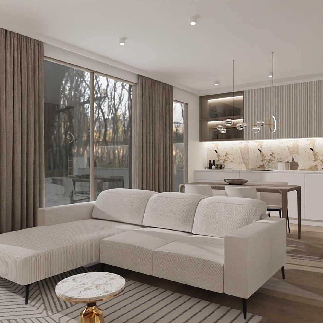 Jasny salon z narożną sofą, marmurowym stolikiem kawowym na złotej podstawie i widokiem na otwartą kuchnię z marmurowym backsplashiem i designerskim oświetleniem.