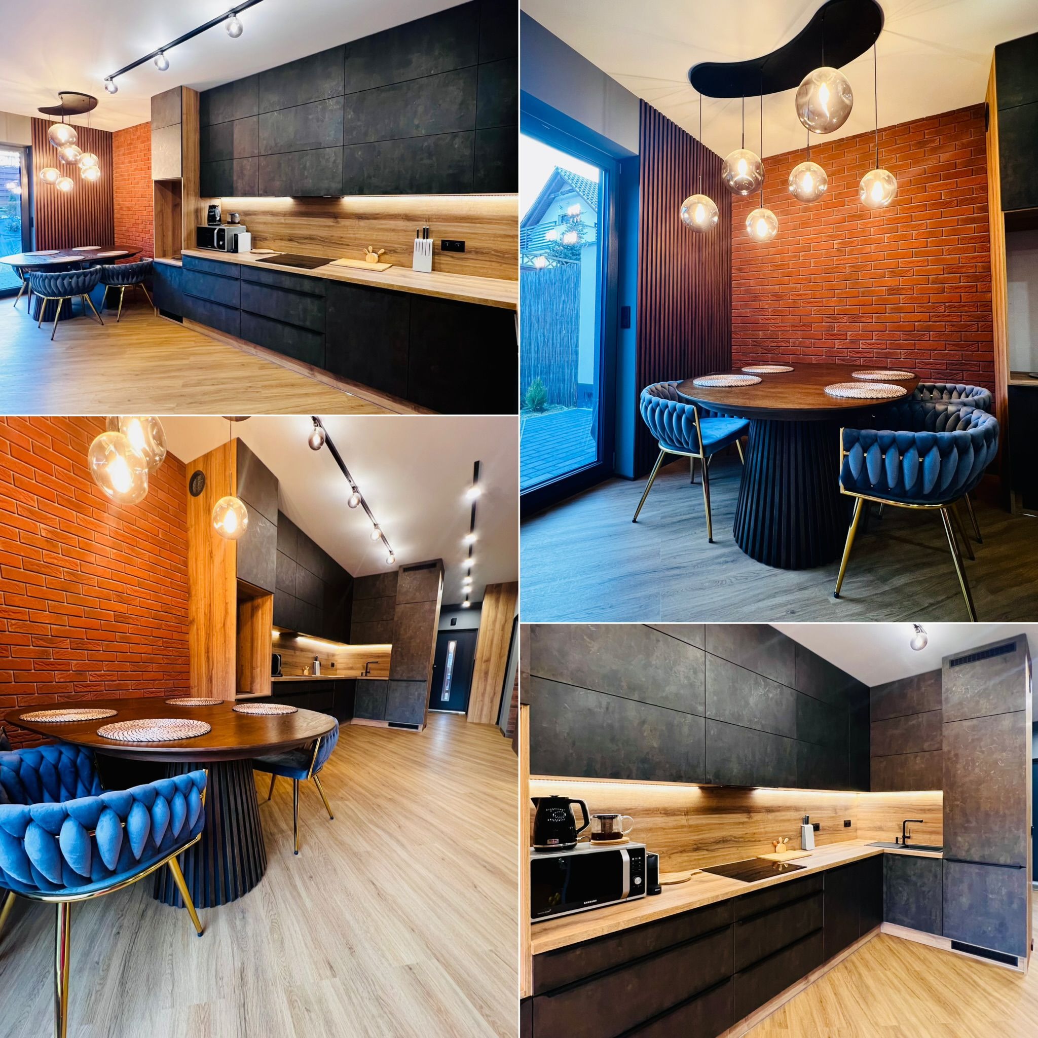Nowoczesna kuchnia z jadalnią: czarne szafki, drewniane blaty, ceglana ściana, okrągły stół z welurowymi krzesłami i designerskie oświetlenie.